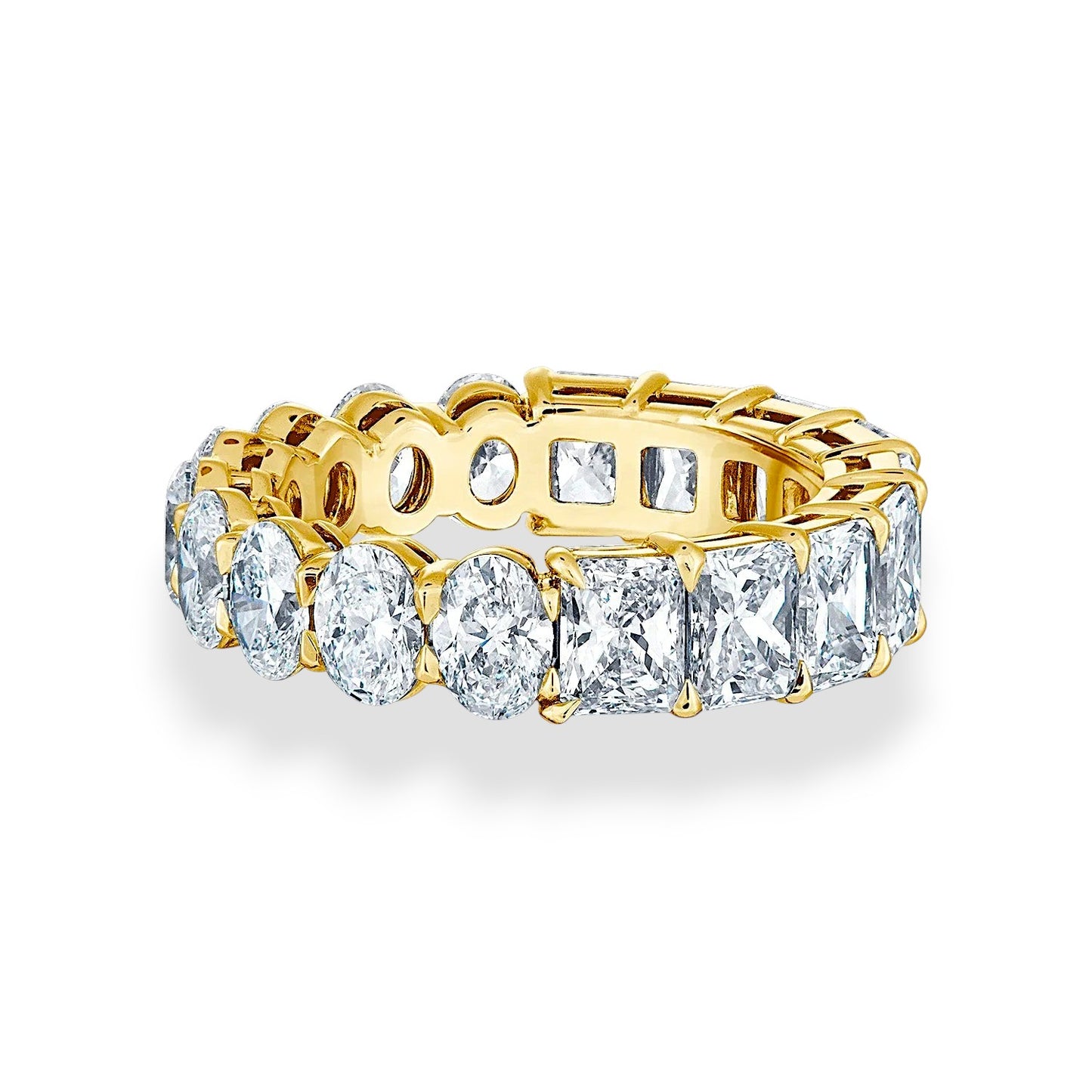 Gold ring with multiple diamonds on a white background, 18K yellow gold eternity band with oval and radiant cut moissanites