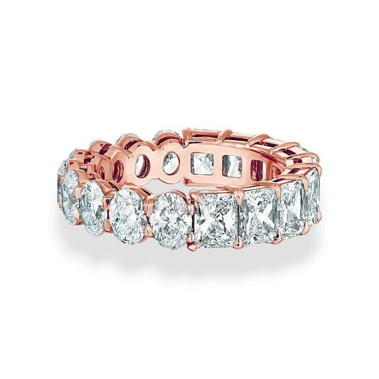Rose gold ring with clear gemstones on a white background