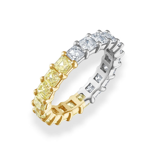 Two diamond eternity rings, one gold and one silver, on a white background.