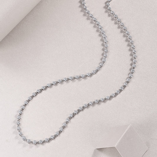 Bezel-set moissanite tennis necklace in gold, round brilliant stones in full circle design. Ethical diamond alternative. Moissanite jewellery Australia