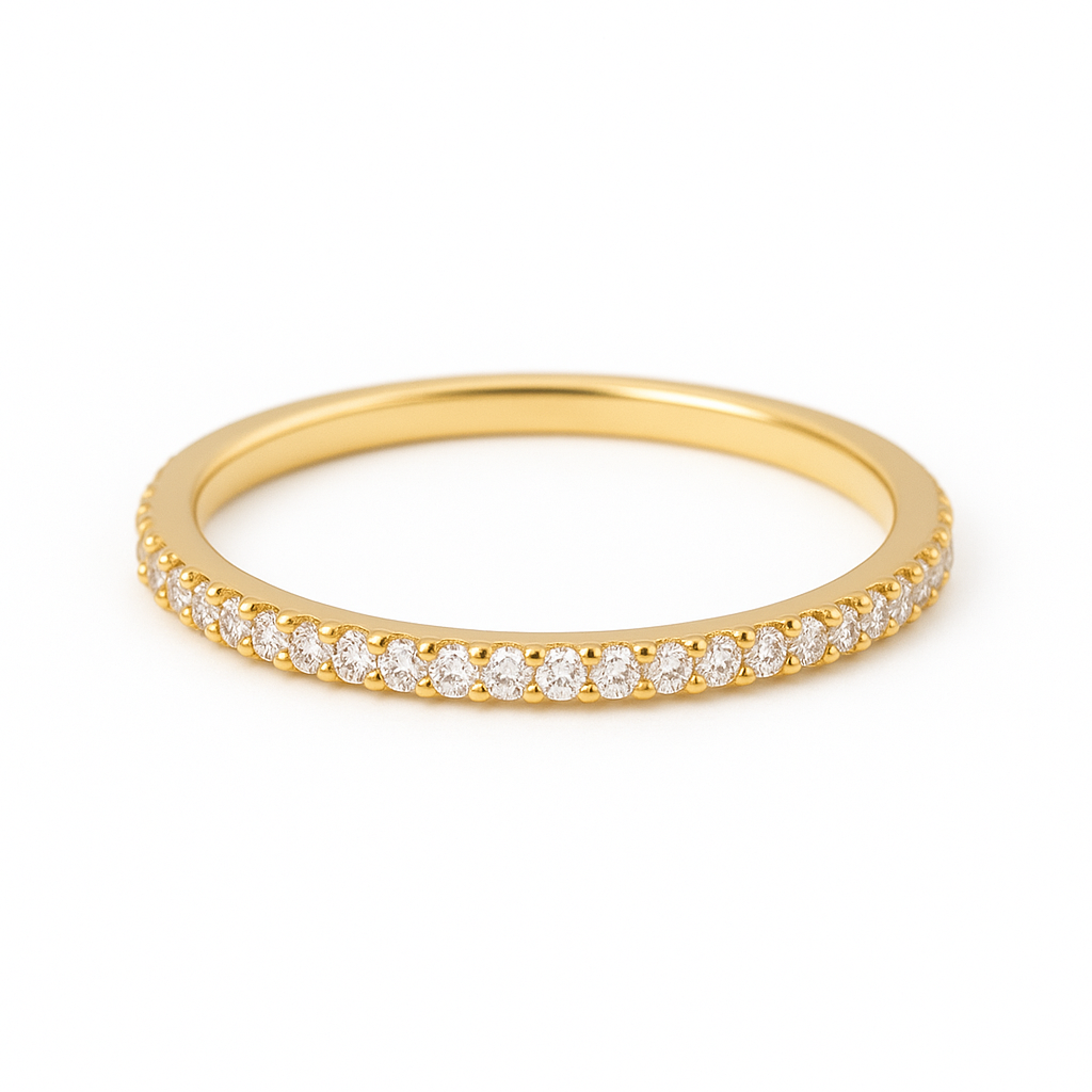 The image above displays the 1.5 mm moissanite eternity ring on a pristine white background. The 14 K yellow gold band is fully encircled by small moissanite stones set in shared prongs, and the soft lighting highlights the ring’s slim profile and meticulous craftsmanship.