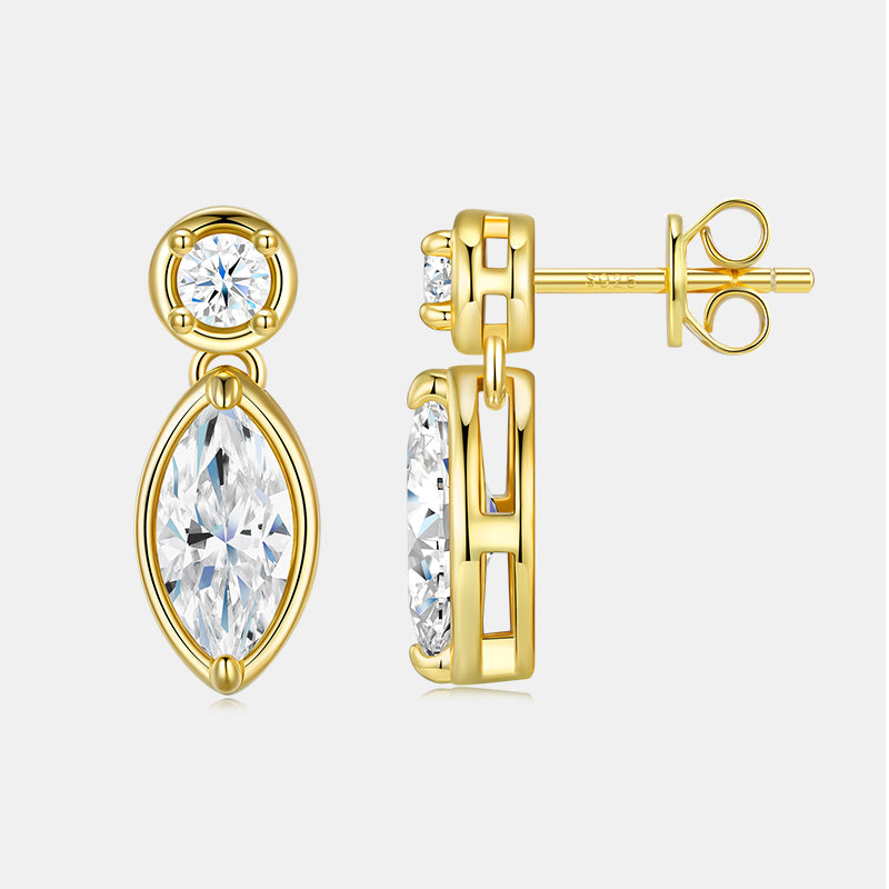 Gold earrings with clear gemstones on a white background