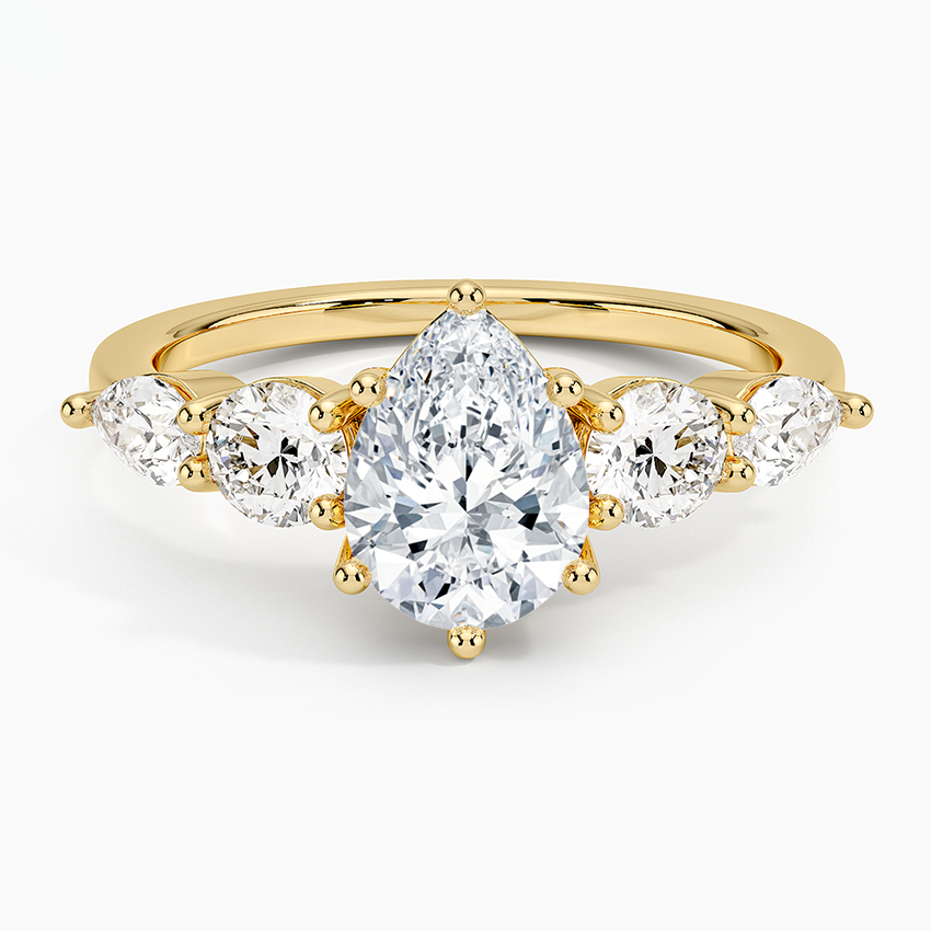 Gold ring with pear-shaped and round diamonds on a white background. Pear Five Stone Moissanite Ring