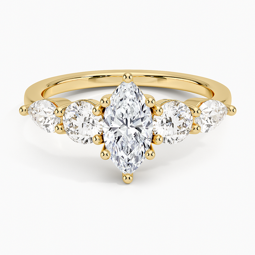 Gold ring with clear gemstones on a white background. Marquise Five Stone Moissanite Ring