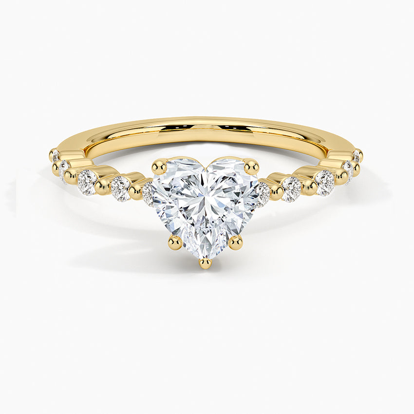Gold ring with a heart-shaped diamond on a white background