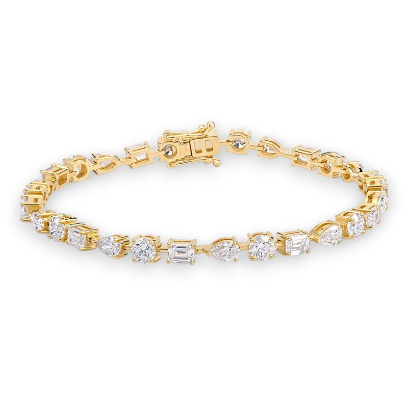Gold bracelet with diamond accents on a white background Pear Emerald East West Round Trilogy Moissanite Diamond Tennis Bracelet