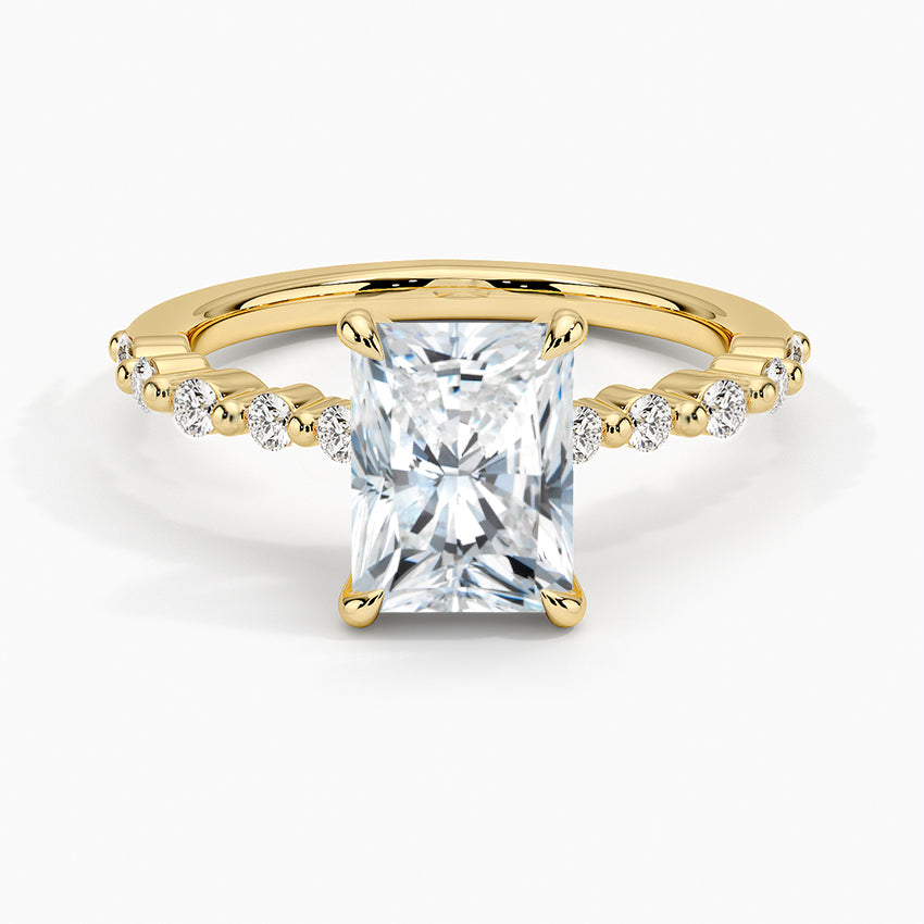 Gold ring with a large diamond and smaller diamonds on the band against a white background
