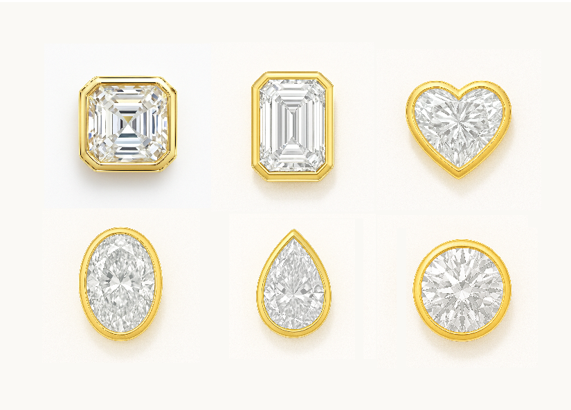 Set of diamond charms with various shapes and gold settings on a white background