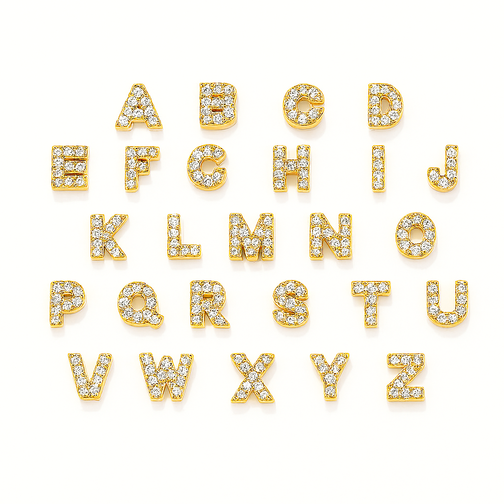 Gold letter earrings with clear stones on a white background