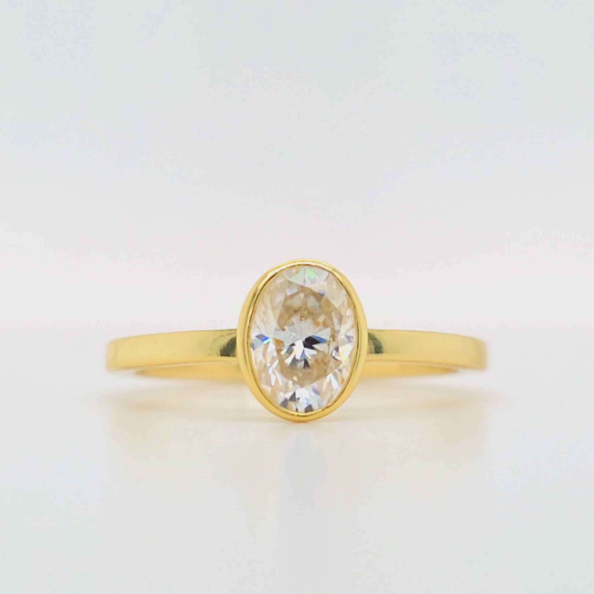 1 carat oval bezel set moissanite ring in gold-plated silver with flat band – modern diamond alternative engagement ring Sydney Australia