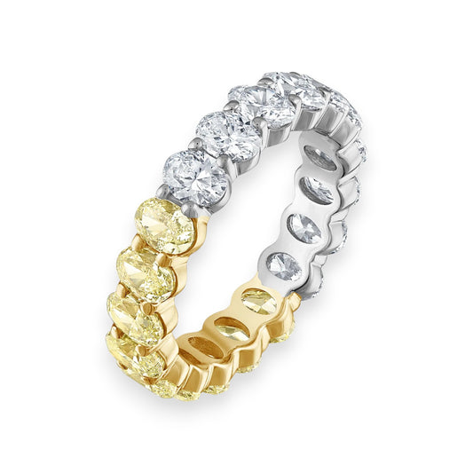 Two-tone diamond ring with yellow and white diamonds on a white background