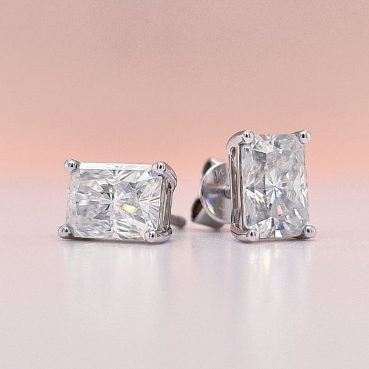 14K Gold earrings with clear radiant cut moissanite diamond gemstones on a white background