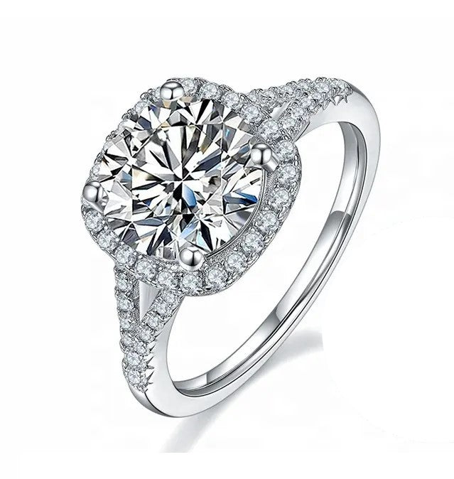 A 3 carat round cut moissanite center stone ring with a split band design, set in a white gold band.