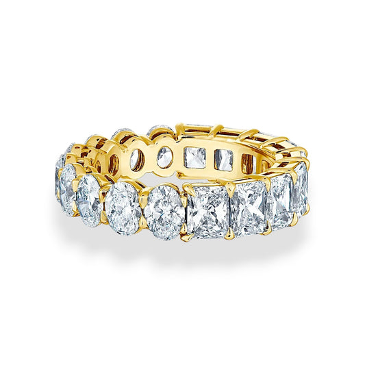 Gold ring with multiple diamonds on a white background, 18K yellow gold eternity band with oval and radiant cut moissanites