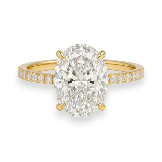 Gold ring with a large diamond and smaller diamonds on the band against a white background. 4.7ct Oval Cut Crushed Ice Moissanite Solitaire Engagement Ring