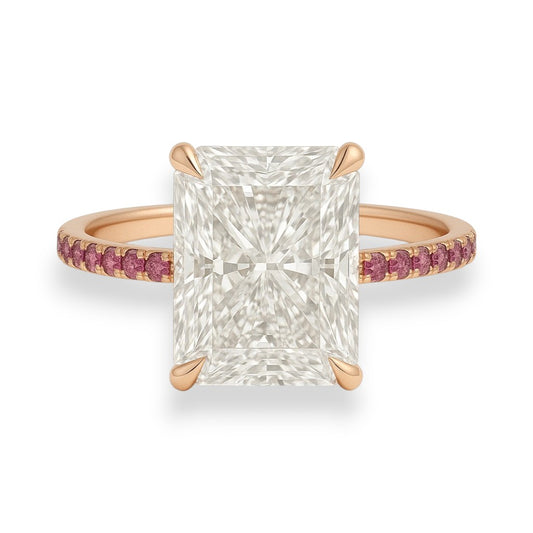 Rose gold ring with a large diamond and smaller pink gemstones on a white background. 5.2ct Radiant Cut Crushed Ice Moissanite Pink Sapphire Engagement Ring