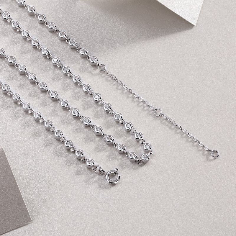 Bezel-set moissanite tennis necklace in gold, round brilliant stones in full circle design. Ethical diamond alternative. Moissanite jewellery Australia