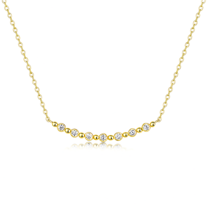 Gold necklace with small diamonds on a white background