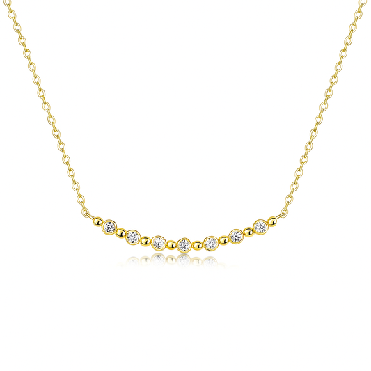 Gold necklace with small diamonds on a white background