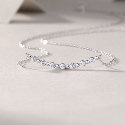 Silver bracelet with small diamonds on a light gray background