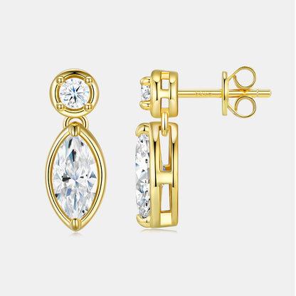 Gold earrings with clear gemstones on a white background