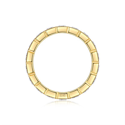Gold ring with a textured band on a white background