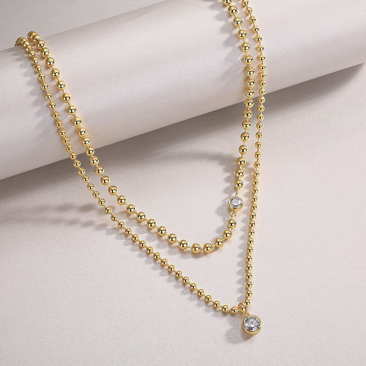 Layered gold beaded necklace with bezel moissanite stones. Ethical moissanite jewellery Sydney. Diamond-inspired layered necklaces Australia