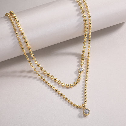 Layered gold beaded necklace with bezel moissanite stones. Ethical moissanite jewellery Sydney. Diamond-inspired layered necklaces Australia