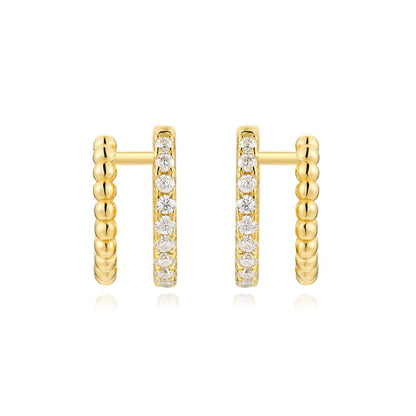 Gold hoop earrings with embedded diamonds on a white background