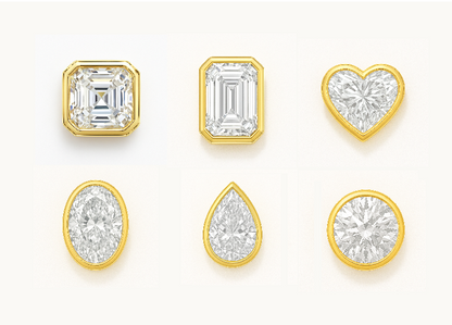 Set of diamond charms with various shapes and gold settings on a white background