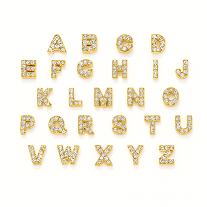 Gold letter earrings with clear stones on a white background