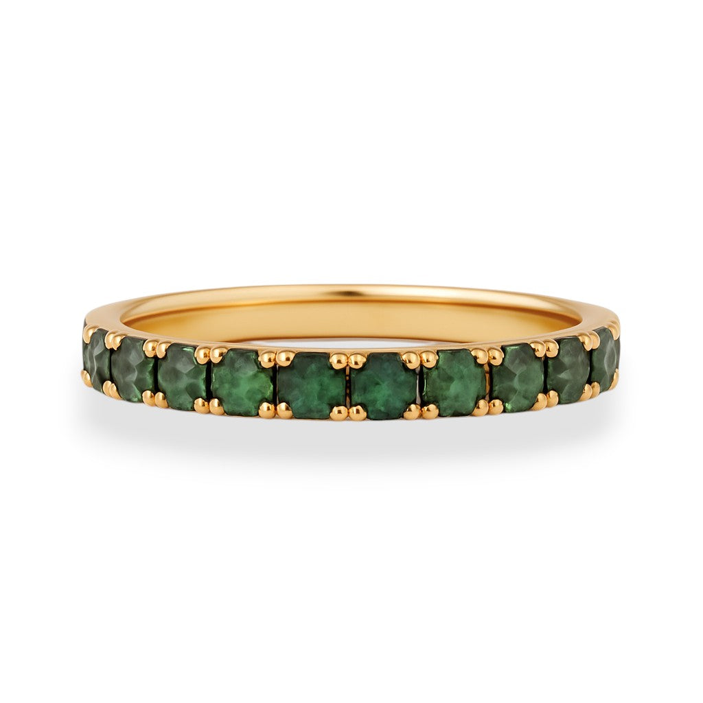 Gold ring with green gemstones on a white background. Gold ring with vivid green moissanite stones, eternity-style, perfect as a pinky ring.