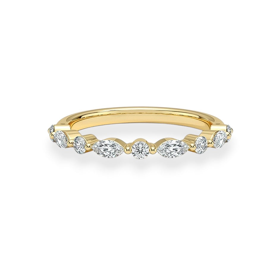 Gold ring with diamonds on a white background. marquise and round moissanites. Elegant and stackable