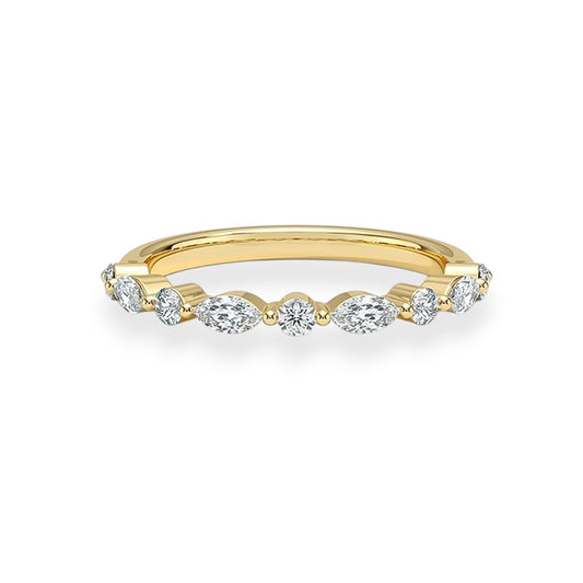 Gold ring with diamonds on a white background. marquise and round moissanites. Elegant and stackable