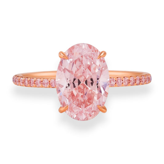 Ring with a pink diamond and rose gold band on a white background. 3.5ct oval lab grown pink diamond ring with matching pink diamond pavé band in rose gold – Gems of Elah