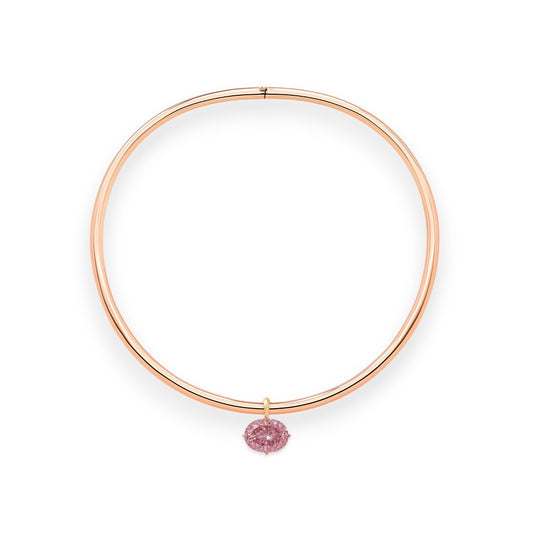 Rose gold torque necklace with a pink diamond on a white background