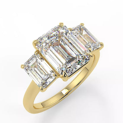 A gold emerald cut trilogy moissanite ring with a twisted band design, featuring a large central moissanite stone and two smaller side moissanites.